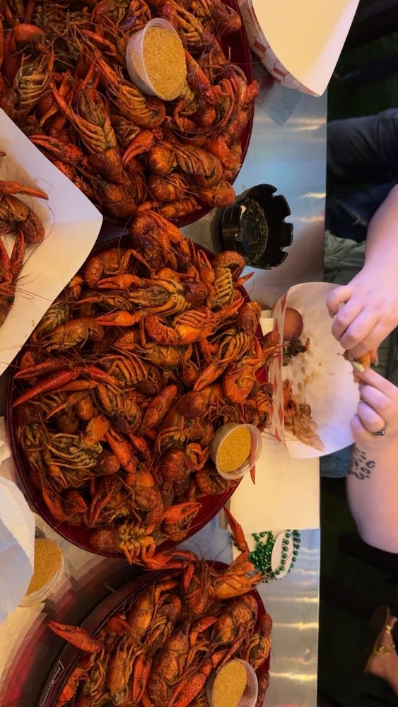 Long tables covered in boiled crawfish at a private event